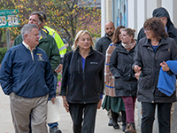 Maine DOT Commissioner Bruce Van Note, Governor Janet Mills, Sanford Mayor Anne-Marie Mastraccio, and others walking through downtown Sanford .